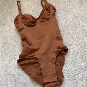Skims One-Piece bodysuit in Brown
